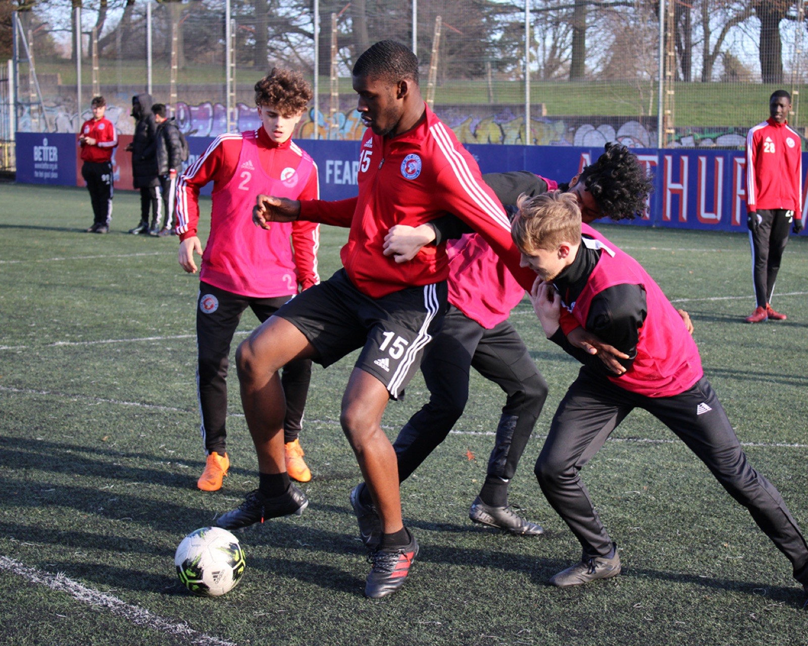 Young footballer training under college floodlights